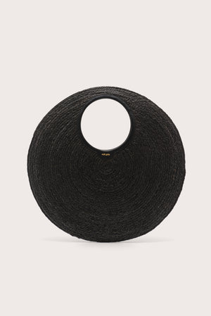 An oversized black woven circular  handbag on a light beige background