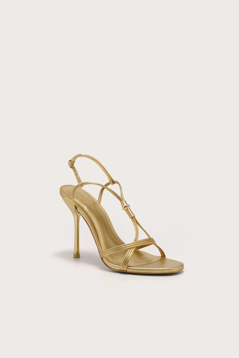 A strappy gold stiletto heel that features gold-toned bamboo hardware.