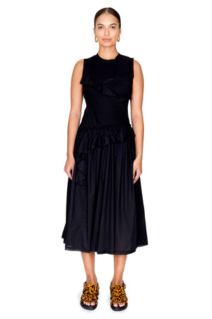 Full body shot of model wearing the cotton voile sleeveless black midi dress with smocking.