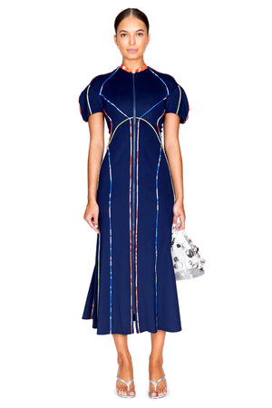 Full body shot of model wearing the scuba-doo seamed zip dress in navy blue.