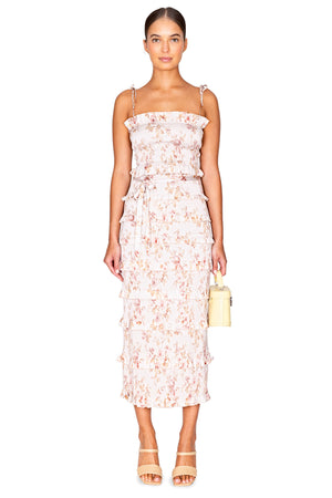 Model facing the camera in the smocked floral print midi dress