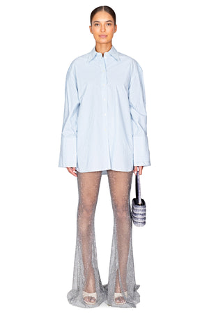 Model styled in the double cuff button down shirt in blue stripe.