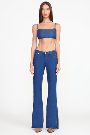 Full body shot of model in the dark rinse bikini jean.