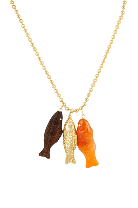 A gold wire necklace with a carnelian agate pendant shaped like a 'Swedish Fish' alongside a brown and gold fish.