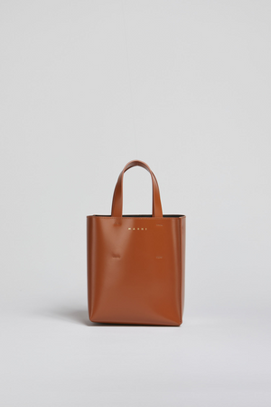 Brown tote bag with 'Marni' branding on a light gray background