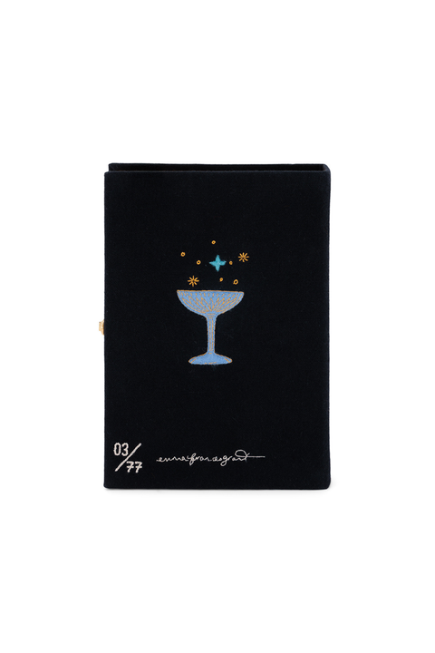 A black book clutch featuring a light blue cocktail glass filled with gold and blue stars, along with white text reading '03/27' and 'unbounded' at the bottom, shown on a plain white background.
