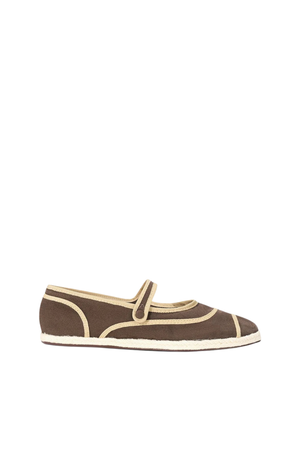 A brown and beige ballerina-style flat shoe with a decorative buckle and an espadrille detail on a white background