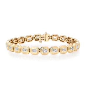 Gold bracelet with embedded diamonds on a white background