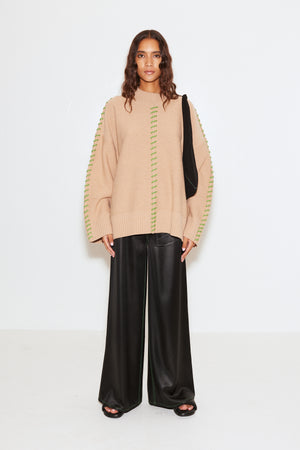 Model styled in the leith brown sweather with contrasting green stitching.