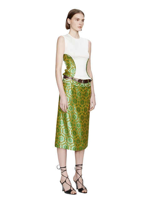 Model wearing a white sleeveless top with green patterned sides and a matching skirt on a white background