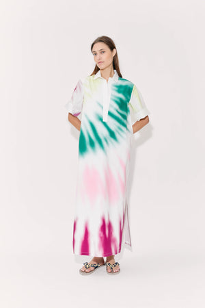 Woman poses in tie-dye maxi dress with collar and cuffed short sleeves.
