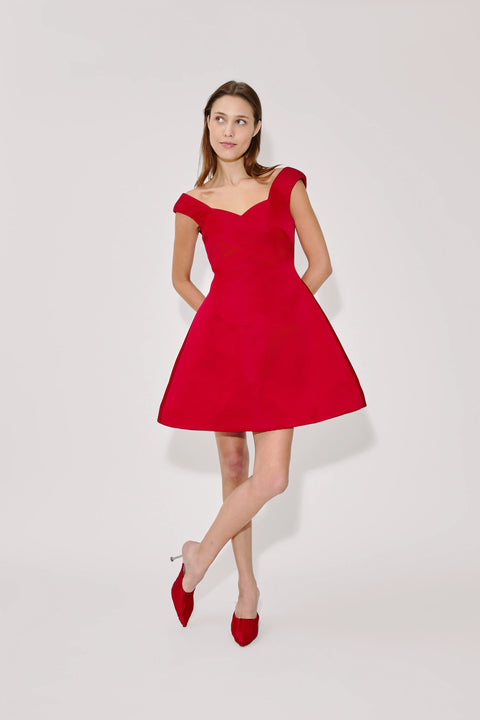 Woman wearing a red dress on a white background