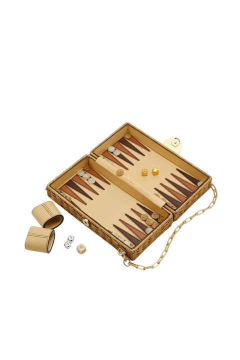 The inside of a wicker bag that is a backgammon set side view