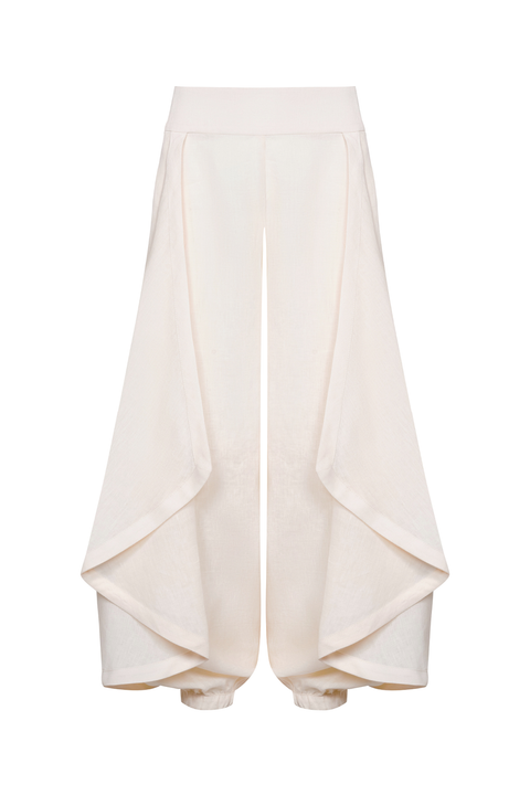 A pair of high-waisted, wide-leg trousers in a soft cream fabric, featuring draped side panels and gathered cuffs, shown against a plain white background.