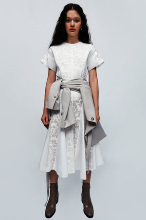 Model wearing the white bonded lace short sleeve pleated combo midi dress.