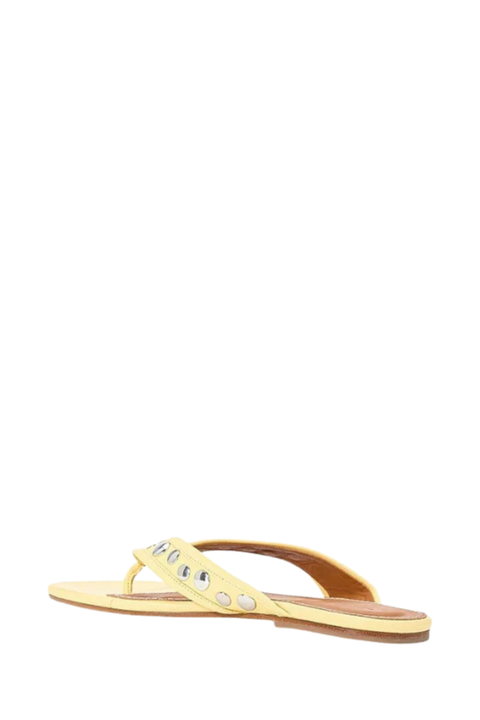 A single pale yellow thong sandal with a studded strap, shown from a side profile against a plain white background.