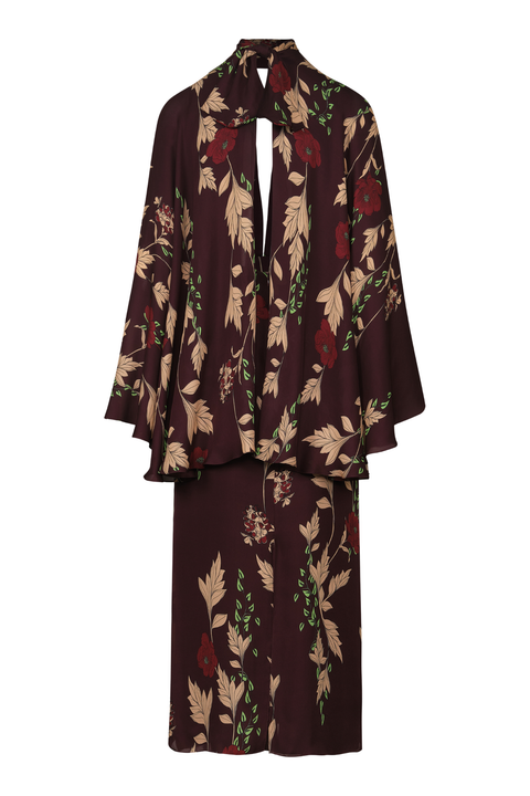 A dark brown long dress featuring a long-sleeve blouse with a keyhole cutout and a matching midi skirt, both decorated with a beige, green, and red floral pattern, shown against a plain white background.