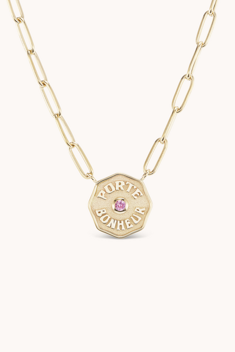 Yellow gold chain necklace with mini 'Porte Bonheur' coin with small pink sapphire in the center.