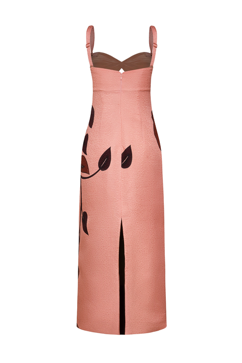 A sleeveless midi dress in dusty pink with a black leaf pattern and a back slit, shown on a plain white background.