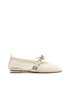 White netted flat shoe with a decorative bow and floral print on a white background