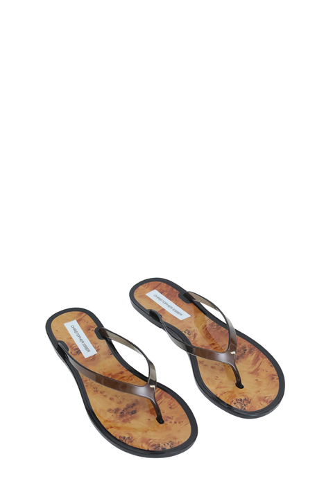 A pair of thong sandals with black clear jelly straps and a printed tan and brown insole, shown on a plain white background.