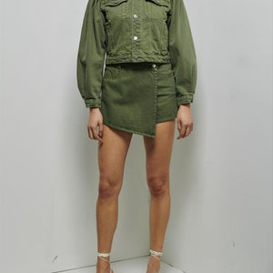 Neck down shot of model wearing the winnie asymmetrical skort in green.