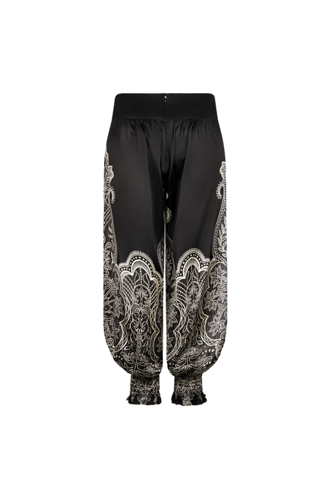 Black harem-style pants with a white and gray ornate paisley print concentrated on the lower legs and cuffs, shown against a plain white background.