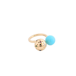 Ring with gold and turquoise beads on a white background