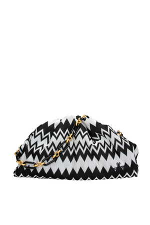 Black and white zigzag patterned clutch bag with gold chain on a white background
