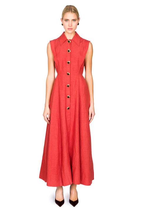 Woman wearing a red sleeveless maxi dress with large buttons on a white background