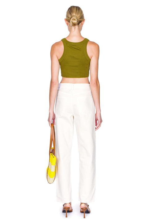 Back of woman wearing cropped green tank top with yellow handbag and cream colored jeans.