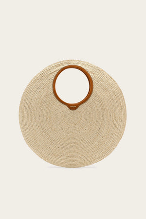 Oversized, circular woven handbag with a tan leather handle lining.