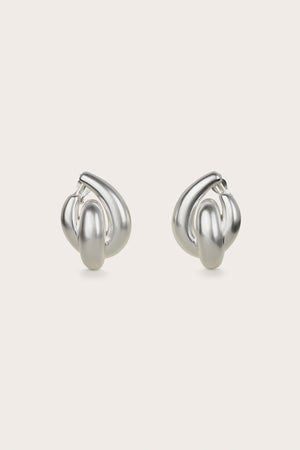 A pair of silver-toned clip-on statement earrings that feature interlocking abstract hoops.