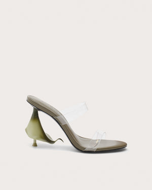 Side profile of a green high heel with clear straps and a calla lily shaped heel.