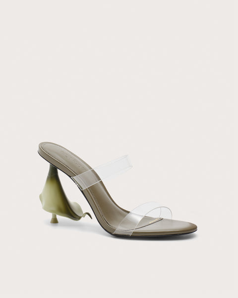 Side profile of a green high heel with clear straps and a calla lily shaped heel.