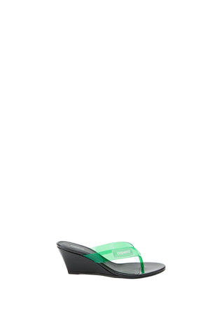 Black wedge sandal with green strap on a white background