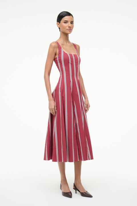 Woman wearing a red and white striped dress on a white background