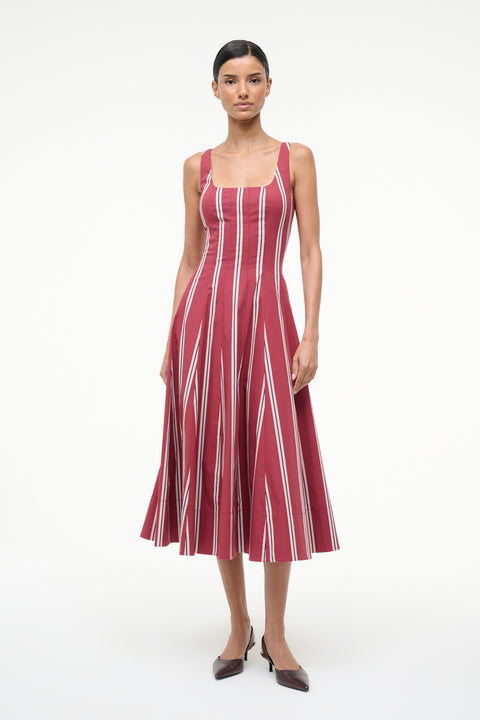 Woman wearing a red and white striped dress on a white background