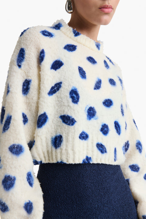 Up close look at cropped sweater with smudge blue kiss print.