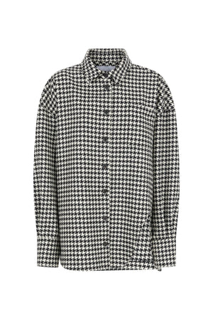 Houndstooth patterned shirt on a light gray background