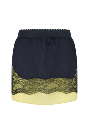 Black mini skirt with black lace trim and birght green underlay on a white background