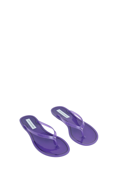 A pair of translucent purple jelly thong sandals on a solid white background.