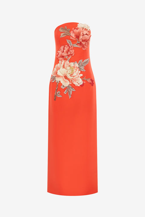 Orange strapless maxi dress with floral embroidery on a white background