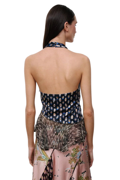 A model shown from the back wearing a halter-neck top with a dark blue patterned upper section and a pink floral lower skirt, against a plain white background.