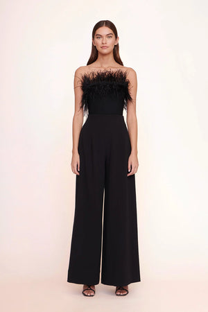 Model facing the camera in the black wide leg pants