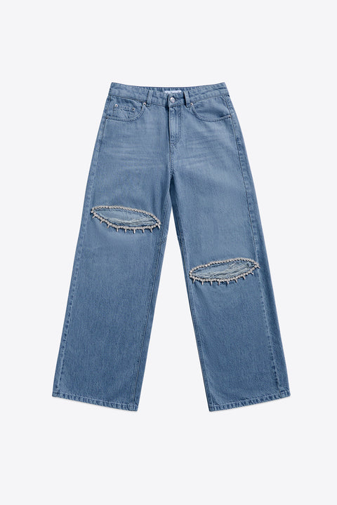 Wide leg light blue jeans with distressing and crystal embellishments  on a white background