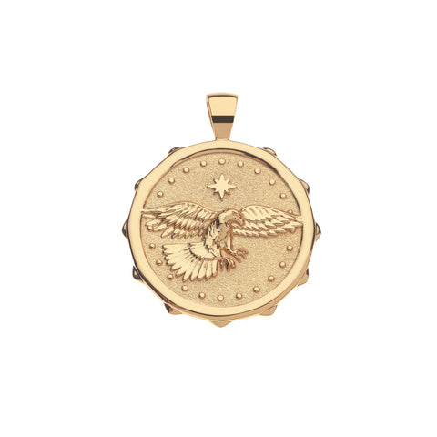 Gold pendant with an eagle design on a white background