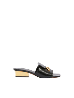 Black heeled sandal with gold buckle detail on the top.