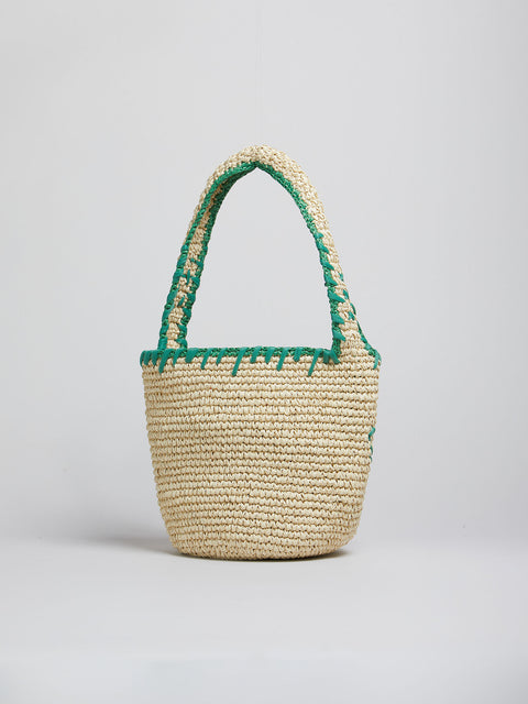 Woven basket with green trim on a light gray background