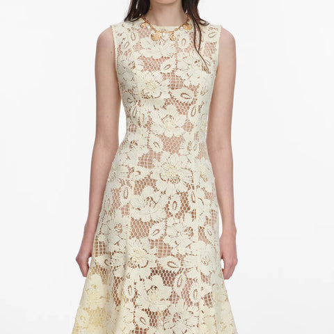 Up close look at yellow sleeveless lace dress on a white background